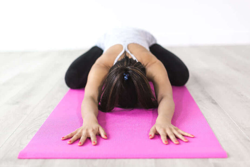 Uitgestrekt op een TPE yogamat